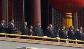 Chinese President Xi Jinping, center, stands with other Chinese leaders to watch a parade as Communist Party celebrates its 70th anniversary in Beijing, Tuesday, Oct. 1, 2019