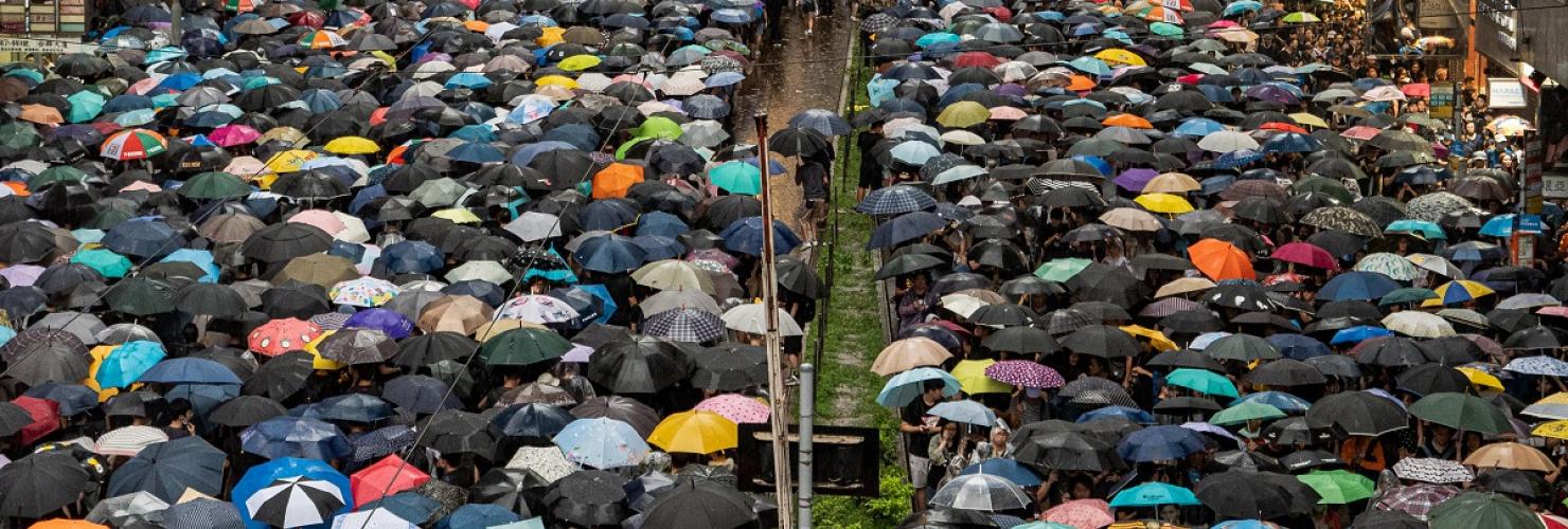Protesters on Hennesy Road in Causeway Bay braving the rain to enter Victoria Park for a demonstration on August 18. Image by Studio Incendo via flickr (CC BY 2.0)