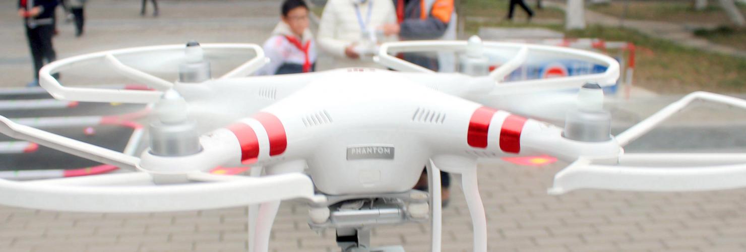 A Chinese girl operates an unmanned aerial vehicle (UAV), or drone, in Suzhou city, east China's Jiangsu province