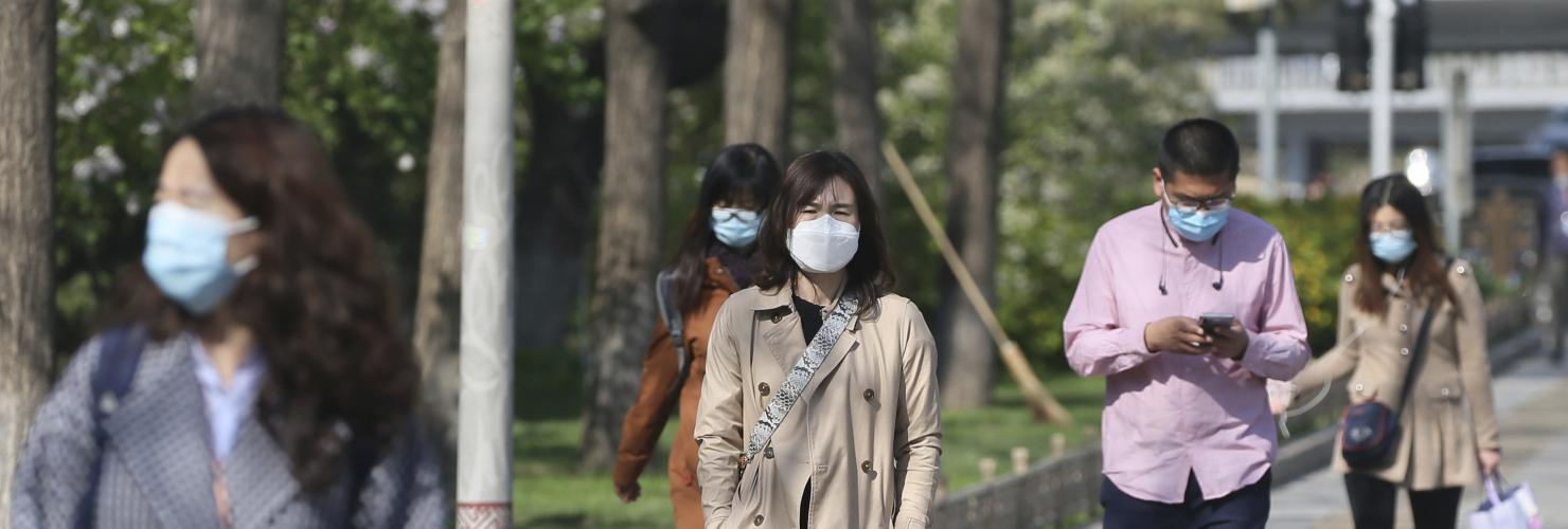 People wearing facemasks at a street in Beijing