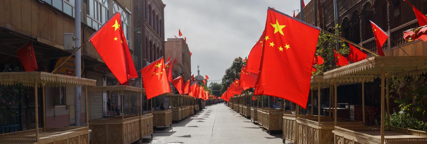 An empty street in Xinjiang with Chinese flags