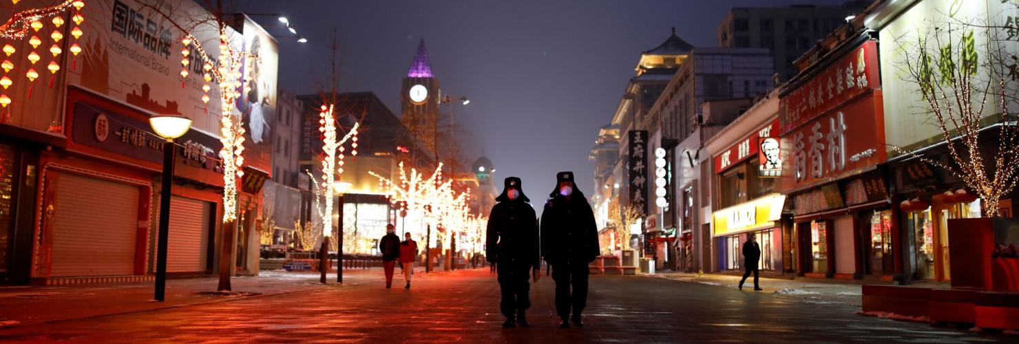 Security guards walking down Wangfujing street in Beijing.