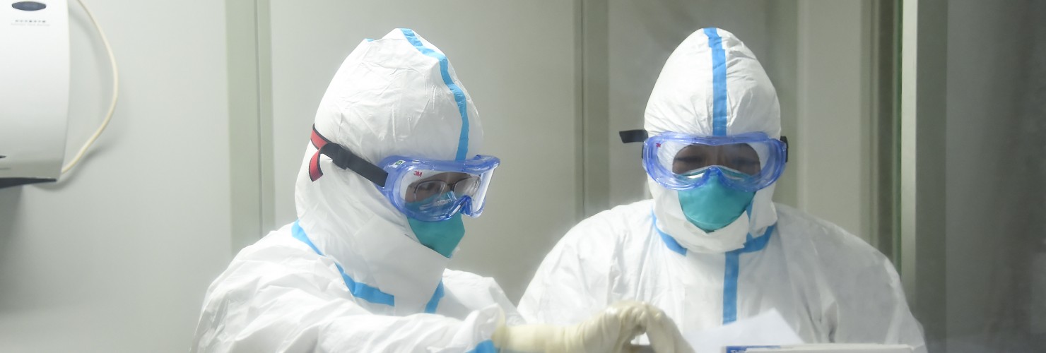 Cao Ting (L) and her colleague prepare to work in the laboratory of Xiaogan's center for disease control and prevention in central China's Hubei Province.