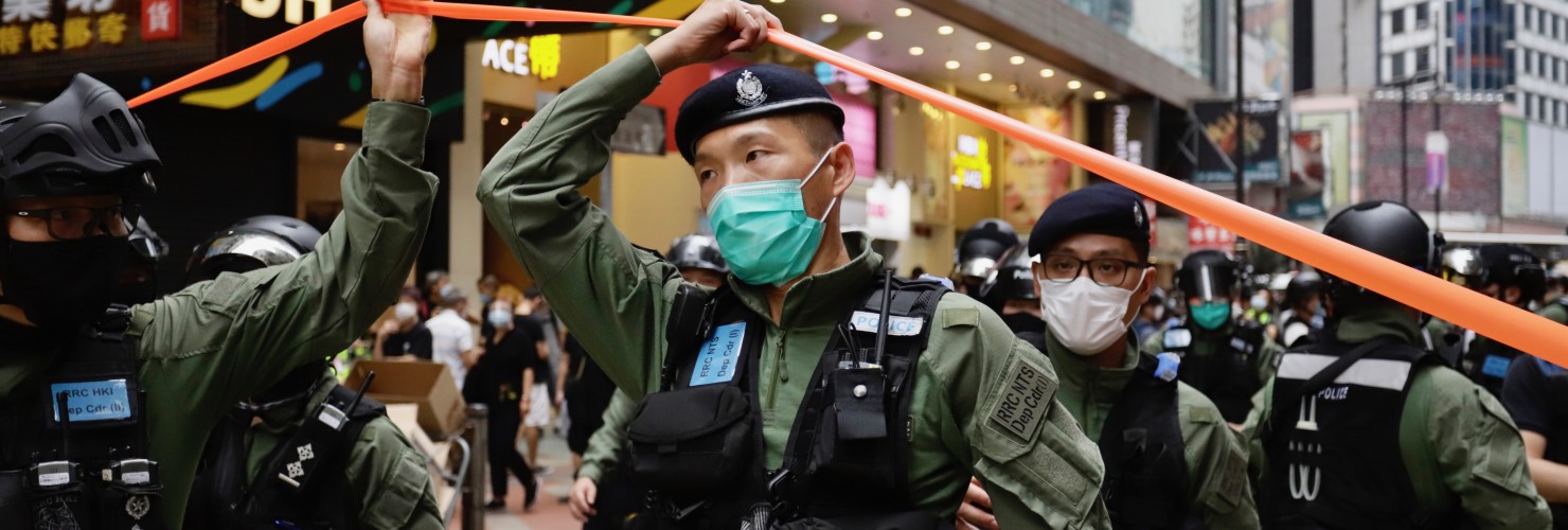 Policeman pass through a cordon line in the city centre on the PRC national day in Hong Kong.
