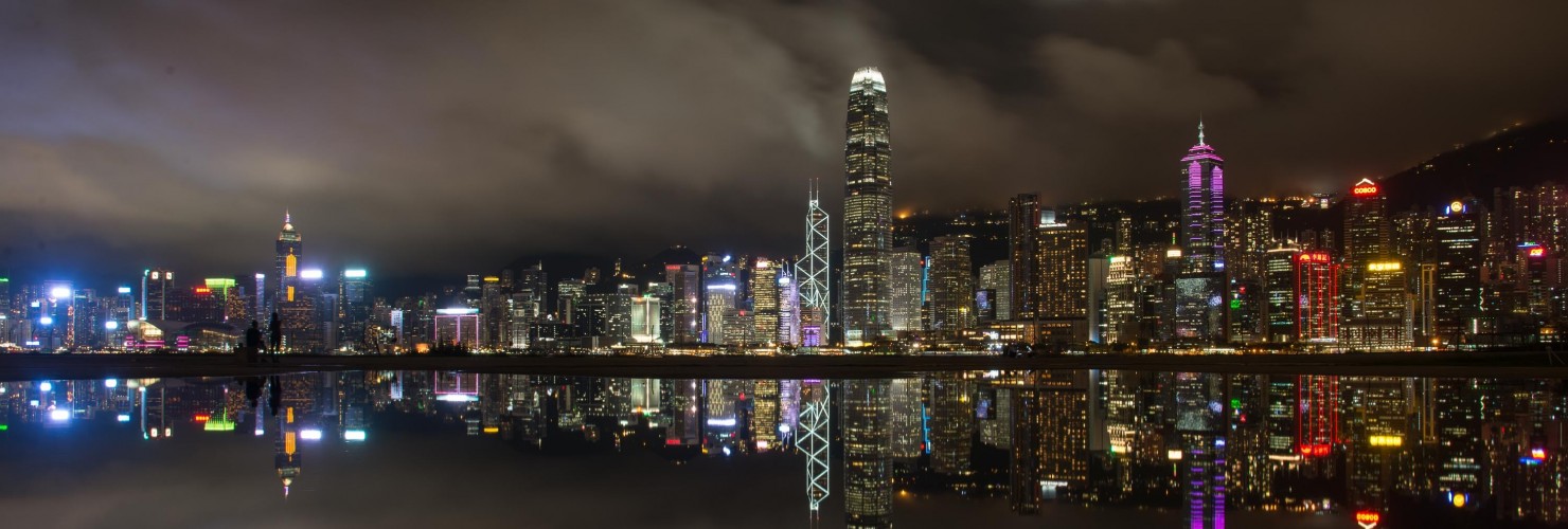 Night view of skyscrapers and high-rise buildings in Central along the Victoria Harbor in Hong Kong
