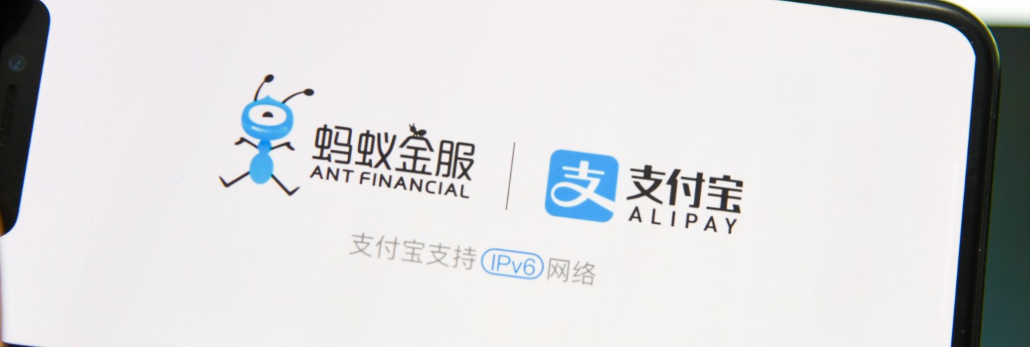 Logos of Alibay and Ant Financial appear on a smartphone screen