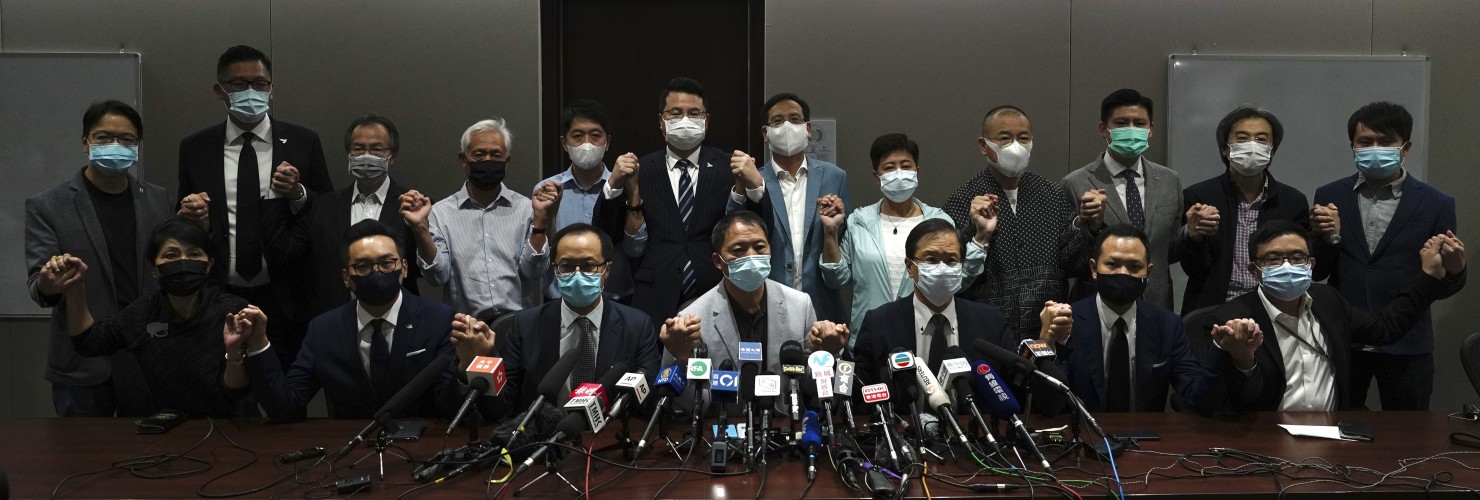 Hong Kong's pro-democracy legislators pose for a photo before a press conference at the Legislative Council in Hong Kong, Wednesday, Nov. 11, 2020.
