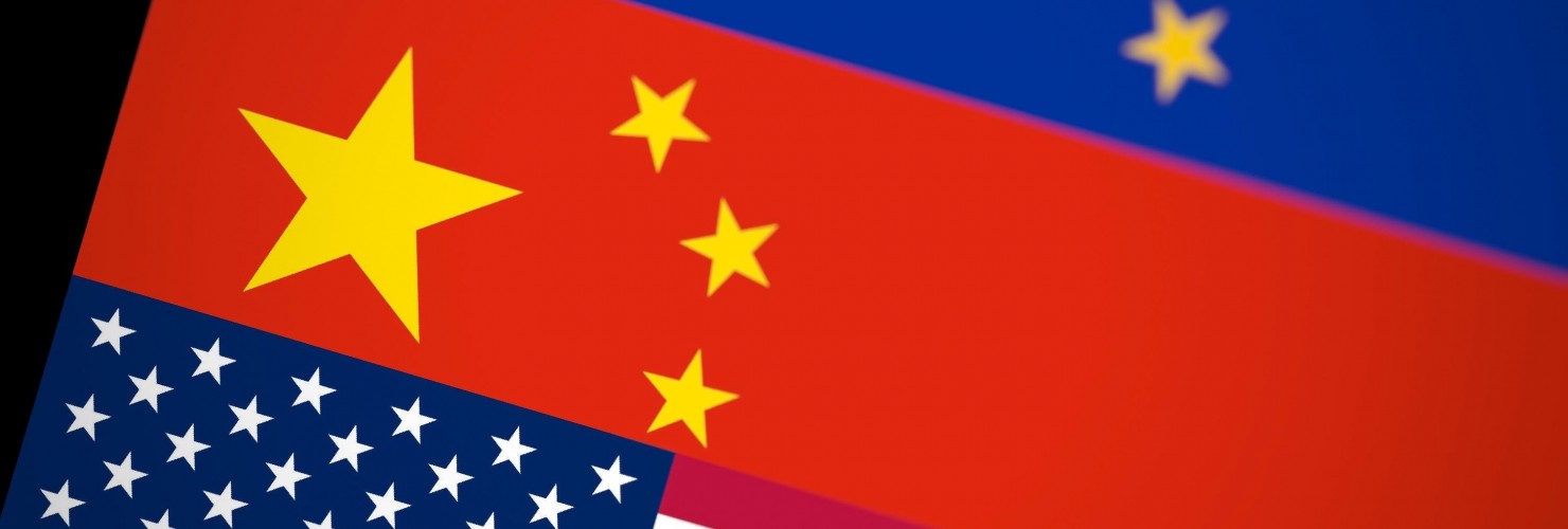 Blurred USA, China and EU flags together on black background