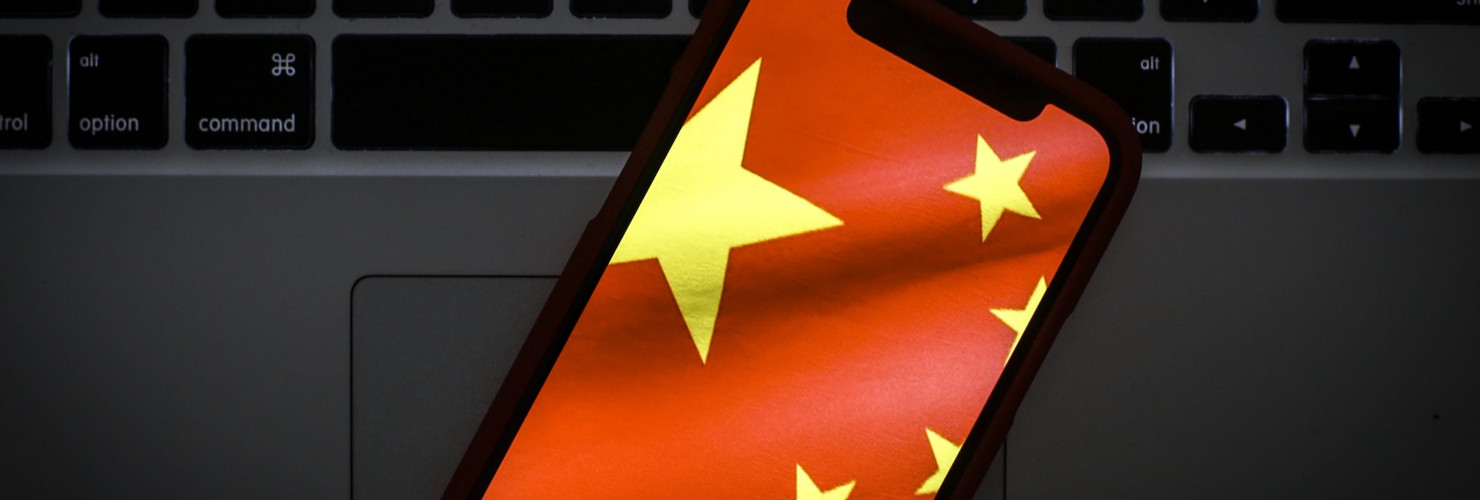 The Chinese flag is seen on a portable mobile device in this photo illustration