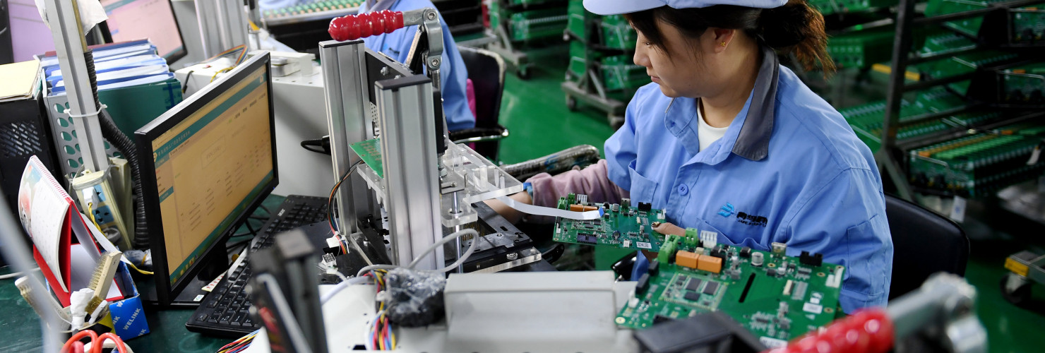 Workers work on a module testing production line in Hebei province, China
