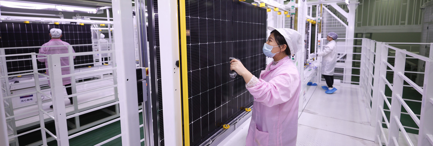A worker at a photovoltaic company works on a production line in Lianyungang City, Jiangsu Province, China, December 15, 2023.