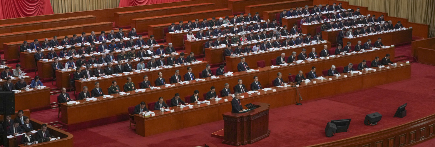 Chinese Premier Li Qiang speaks from a lectern during the opening session of the National People's Congress (NPC) at the Great Hall of the People in Beijing, China, Wednesday, March 5, 2025.