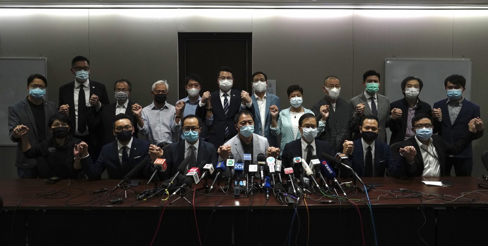 Hong Kong's pro-democracy legislators pose for a photo before a press conference at the Legislative Council in Hong Kong, Wednesday, Nov. 11, 2020.