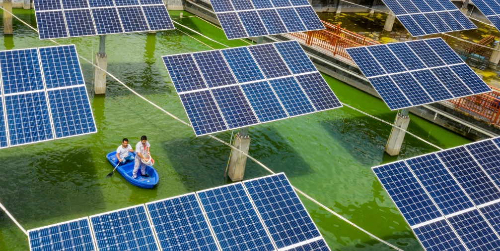 Aerial view of the fishermen working at a fishing area where photovoltaic power panels are used to generate power in Wuzhou city, south China's Guangxi Zhuang autonomous region