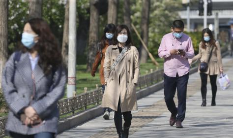 People wearing facemasks at a street in Beijing