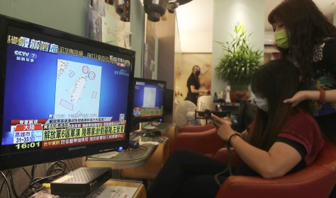 A TV news shows a map marking the areas where China is conducting live fire exercises near Taiwan, at a beauty salon in Taipei, Taiwan, Thursday, Aug 4, 2022