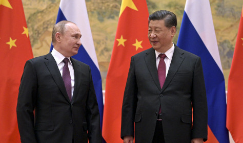 Chinese President Xi Jinping, right, and Russian President Vladimir Putin talk to each other during their meeting in Beijing, China, Friday, Feb. 4, 2022.