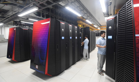 Engineers work on the server cabinets in a new section of Wuhan Supercomputing Center in Wuhan.