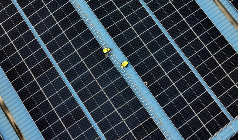 Construction workers install photovoltaic modules on the roof of Tongwei Electric Haian Co., LTD in Hai 'an, Jiangsu province, China, November 19, 2024.