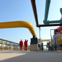 Technicians inspect pipelines at a liquefied natural gas (LNG) terminal operated by China Petrochemical Corporation (Sinopec Group)