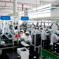 Workers work on a production line to produce electrical products for domestic and Southeast Asian markets in Nantong