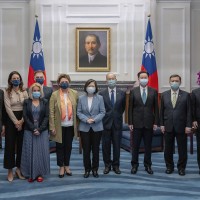 In this photo released by the Taiwan Presidential Office, Taiwan's President Tsai Ing-wen, center right, pose for photos with European Parliament Vice President Nicola Beer, center left, and her delegation at the Presidential Office in Taipei, Taiwan on Wednesday, July 20, 2022.