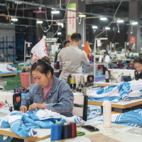 Workers make an order at a workshop of a clothing company