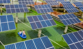 Aerial view of the fishermen working at a fishing area where photovoltaic power panels are used to generate power in Wuzhou city, south China's Guangxi Zhuang autonomous region