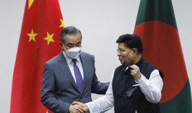 Chinese Foreign Minister Wang Yi, left, stands with his Bangladeshi counterpart A.K. Abdul Momen during their meeting in Dhaka,
