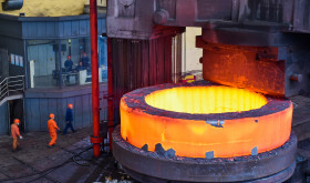 Chinese workers check a seamless forging piece at a forging workshop of CITIC Heavy Industries Company in Luoyang city, central China's Henan province