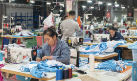 Workers make an order at a workshop of a clothing company