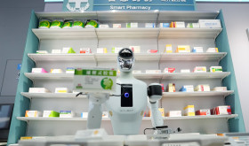 A Galbot humanoid robot plays the role of a shop assistant in a simulated pharmacy in Beijing Economic-Technological