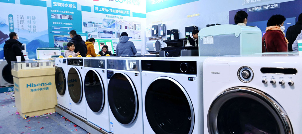Chinese citizens look at home appliances. The Chinese government introduced trade-in programs on costlier household purchases like washing machines and fridges to lift consumption in Q2 2025.